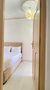 a bedroom with a bed and a light fixture at Dar Betty in Essaouira