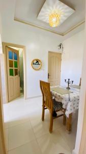 a dining room with a table and a chair at Dar Betty in Essaouira +6 photos