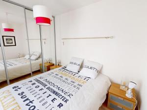 a bedroom with two beds with white walls and red lamps at Appartement moderne 3 chambres, terrasse, proche plage et commerces - FR-1-785-12 in Mèze