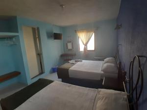 Ένα ή περισσότερα κρεβάτια σε δωμάτιο στο Casona Doña María Elena