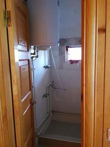 a small bathroom with a shower with a shower at Holiday Cottage in Ureki, Georgia in Ureki