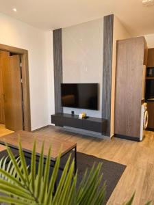 a living room with a flat screen tv on a wall at Alshakreen suites in Amman