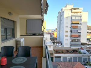 a balcony with a projection screen on a building at Evans Realty BF Parking & Piscina & Terraza in Fuengirola +28 photos