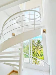 a spiral staircase in a house with a window at Luxury Pool Villa 99 in Ban Bang Krang +21 photos