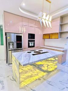 a kitchen with a counter with a painting on it at Luxury Pool Villa 99 in Ban Bang Krang