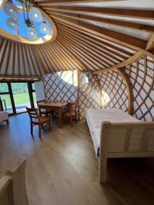 a bedroom with a bed and a table in a room at Magic Rock Tourist Camp in Nalayh