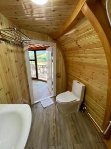 a bathroom with a toilet and a sink at Magic Rock Tourist Camp in Nalayh +86 photos