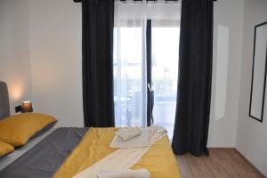 a bedroom with a bed and a large window at Apartments Rismondi 37D in Fažana