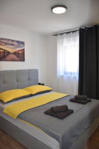 a bedroom with a large bed with yellow pillows at Apartments Rismondi 37D in Fažana +38 photos