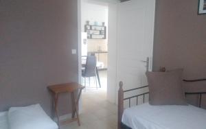 a bedroom with a bed and a table and a kitchen at Ανδρος Αρκουδα in Andros
