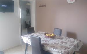 a dining room table with a bowl of fruit on it at Ανδρος Αρκουδα in Andros