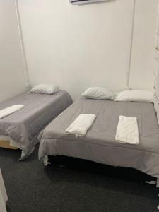 two beds sitting next to each other in a room at Breeze Manor in Scarborough +9 photos