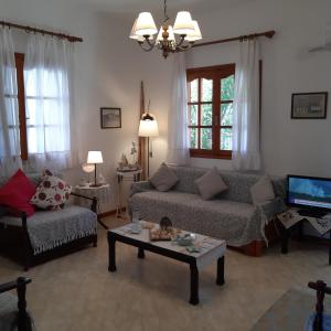 a living room with a couch and a coffee table at Captain's Beauty & Wellness House in Stratónion +113 photos