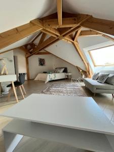 a living room with a white table in a attic at Villaveyron in Roussennac +31 photos