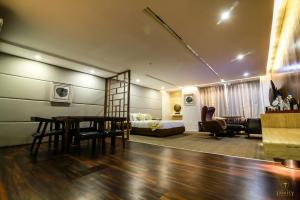 a living room with a table and a couch at Hotel Trinity Grand, Raigarh in Raigarh