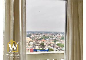 a window with a view of a city at Warisan Bonda Homestay, KTC Kota Bharu in Kota Bharu +6 photos