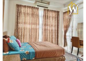 a bedroom with a bed and a window with curtains at Warisan Bonda Homestay, KTC Kota Bharu in Kota Bharu