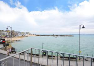 a view of a beach with benches and a street light at 1 Copper Kettle Apartment in St Ives