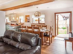 a living room and kitchen with a couch and a table at Beinn View House in Cononbridge