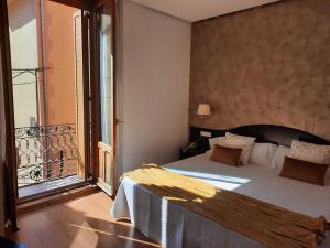 a bedroom with a large bed and a balcony at Hotel Villa de Biar in Biar