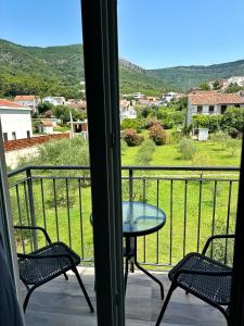 a balcony with a table and chairs and a view at Nirvana S in Tivat