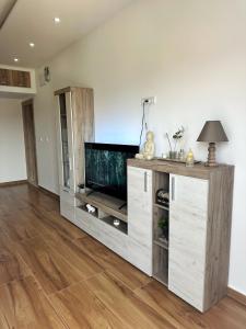 a living room with a entertainment center with a flat screen tv at Nirvana S in Tivat