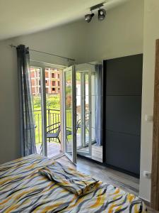 a bedroom with a bed and a balcony at Nirvana S in Tivat