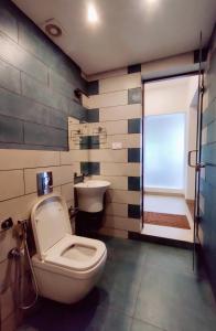 a bathroom with a toilet and a sink at ExoticaHolidays in Sultan Bathery