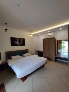 a large bedroom with a large bed in it at ExoticaHolidays in Sultan Bathery