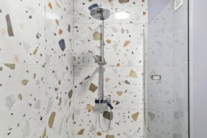 a bathroom with a shower with a shower head at Azure Bliss Terrace Apartaments in Mamaia Nord +20 photos