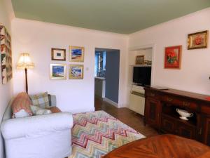 a living room with a couch and a television at Castleside Croft in Kildonan