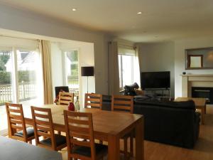 a living room with a table and a couch at Glen Rosa Lodge in Brodick
