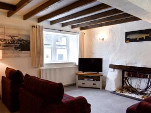 a living room with a couch and a fireplace at Woodlea Cottage 2 in Dippin