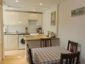 a kitchen with a table and a counter top at Hamilton Terrace in Lamlash