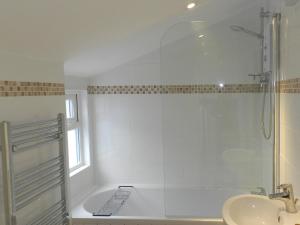 a bathroom with a shower and a sink at Hamilton Terrace in Lamlash +4 photos