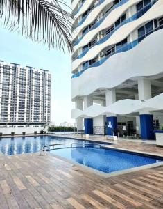 a swimming pool in front of a large building at The Wave - 3R3BR Duplex Penthouse l 10 Pax l Near Jonker l A23A15 in Melaka