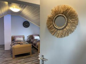 a living room with a mirror and a couch at Casa del Sol in Reinsfeld