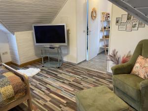 a living room with a flat screen tv and a couch at Casa del Sol in Reinsfeld +30 photos