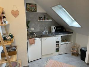 a small kitchen with a sink and a stove at Casa del Sol in Reinsfeld