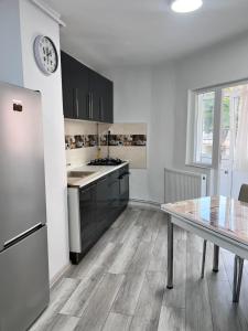 a kitchen with a table and a clock on the wall at Edy&clau in Cîmpulung