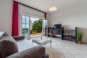 a living room with a couch and a table at Apartments Claudia in Šmrika