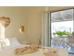 a bedroom with a bed with a blanket on it at Portes Houses in Koufonisia