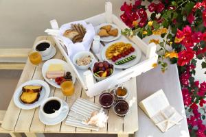 a table with a tray of breakfast foods and drinks at Portes Houses in Koufonisia