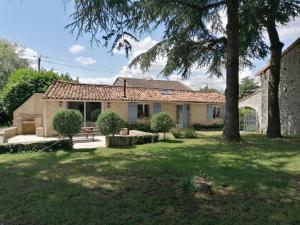 a house with a tree in the yard at Lodge in Saint-Ciers-Sur-Bonnieure in Saint-Ciers-sur-Bonnieure