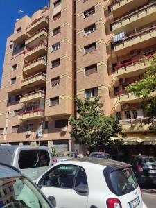 a white car parked in front of a tall building at Vacanze Romane in Rome