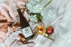 a bottle of wine and some fruit and a glass at Apple Cider Lodge in Omaha