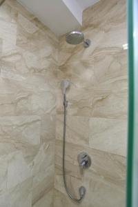 a shower with a shower head in a bathroom at Luxury apartment with 2 rooms in hotel Tre canne in Budva