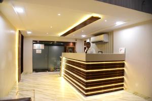 a man standing at the counter of a restaurant at Hotel Grace in Gwalior
