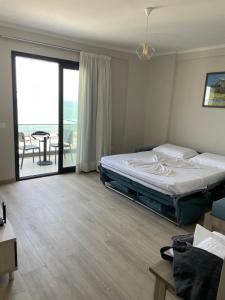 a bedroom with a bed and a view of the ocean at Curoj Luxury Apartments in Radhimë