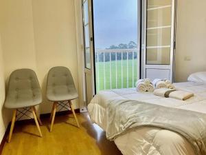 En eller flere senge i et værelse på EL BALCON DE LUARCA